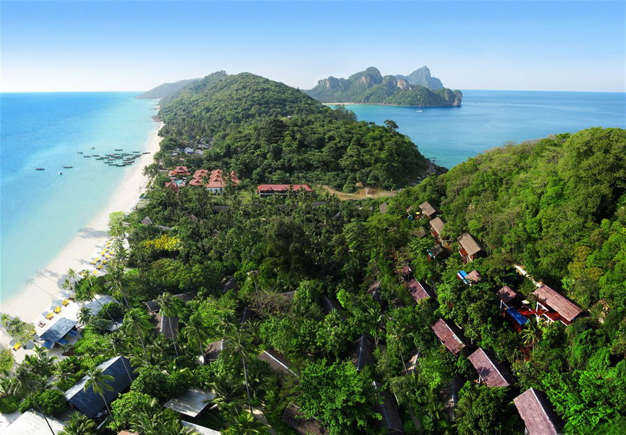 An aerial view of villas surrounded by rainforest and beaches in Koh Phi Phi, Thailand