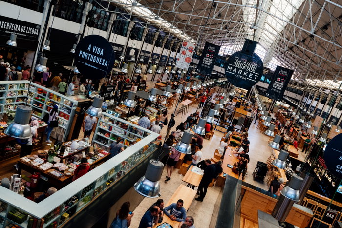 The busy food court of the Time Out food market in the Mercado da Riberia, Lisbon; Healthy Eating vibrant color International Landmark eating capital cities city break busy diner Lisbon table photography indoors relaxation market hall bar portugal city europe famous place tourism dining horizontal Portuguese Culture crowded people leisure activity restaurant panoramic baixa cafe cafe culture european union European Culture landmark travel destinations market street food city life tourist Food Service Occupation vacations vitality
