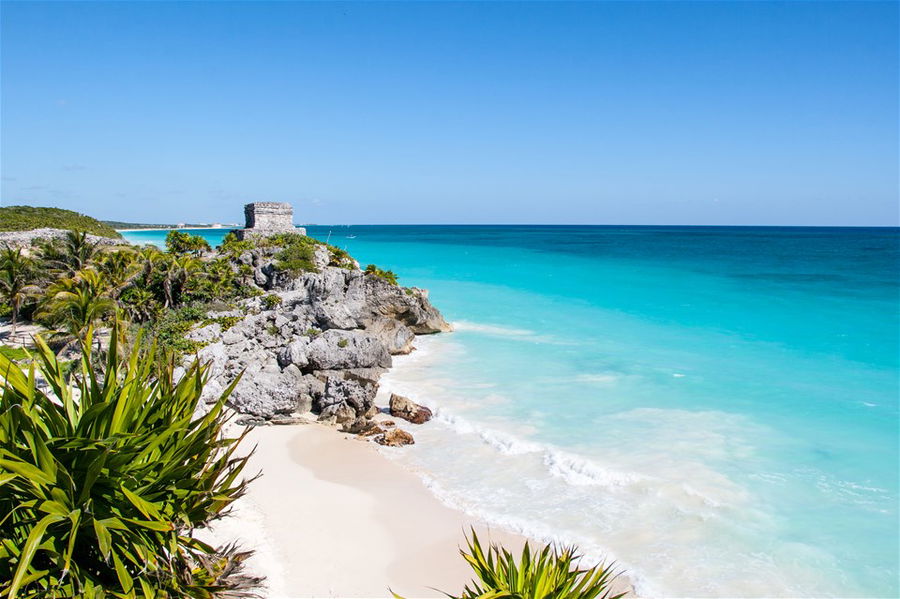 Mayan ruins overlooking Tulum beach on a bright sunny day