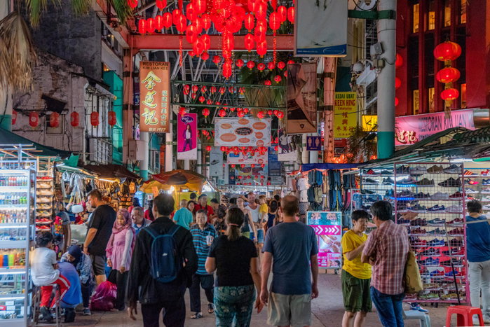 This is Petaling Street at night, a famous shopping area in Chinatown, Kuala Lumpur - asia attraction busy chinatown chinese city cityscape crowd culture destinations downtown entrance famous place jalan kuala lumpur landmark lanterns lights malaysia market marketplace night people petaling street shopping souvenirs stalls tourism tourists traditional travel urban vendors