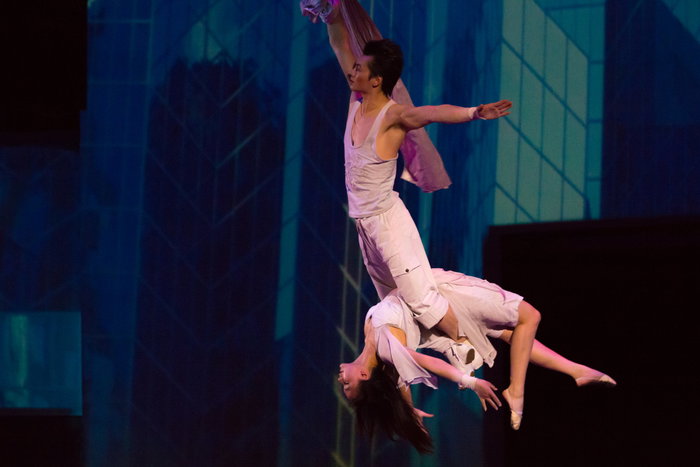 Couple of acrobats hanging on a wire, Shanghai, China