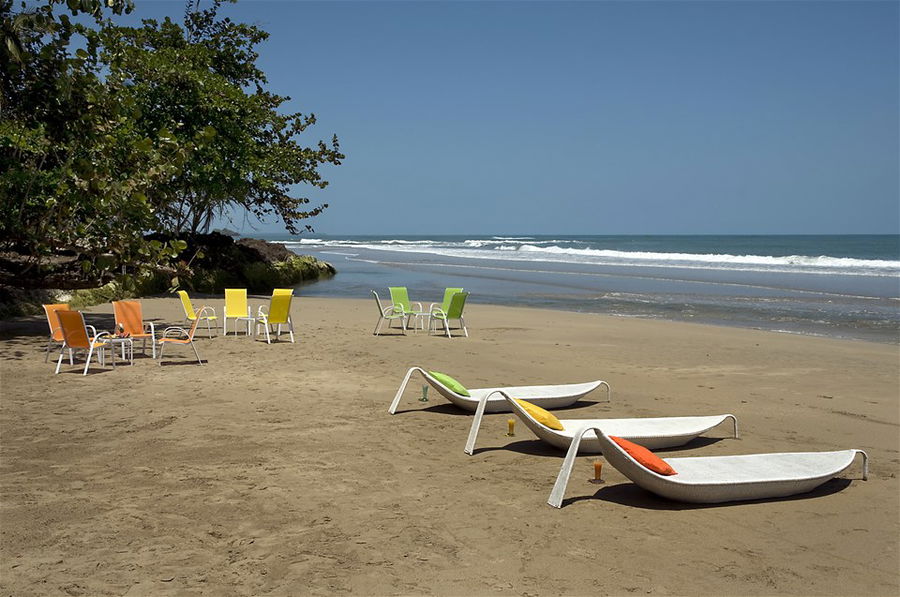 Surfboards line a golden sand beach in Costa Rica