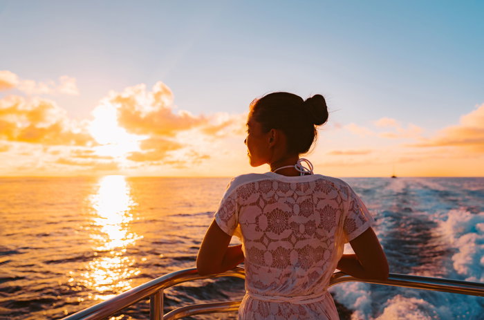 Cruise ship vacation woman watching sunset boat deck on summer travel
