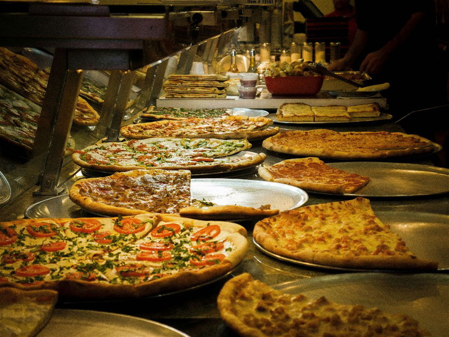 Pizzas on a counter in a deli in New York City