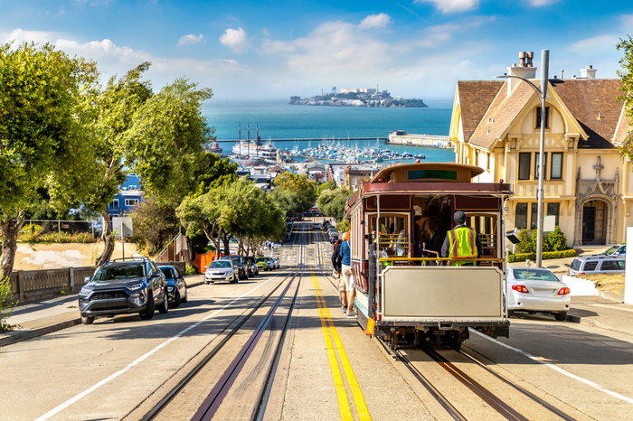 The Cable car tram and Alcatraz prison island on a background in San Francisco, California, USA