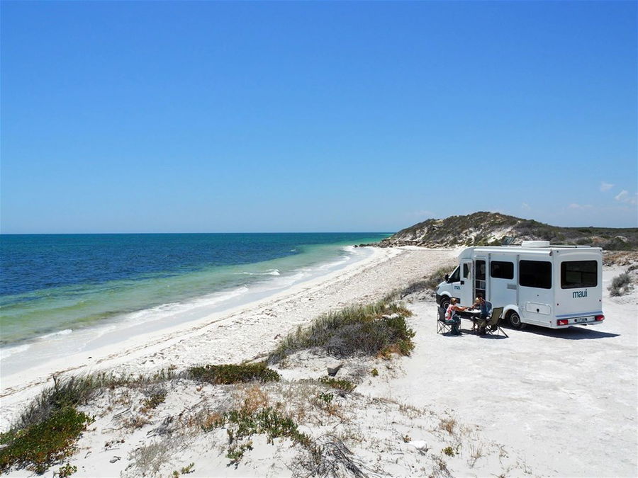 A motorhome parked on a white sand beach on Australia's east coast