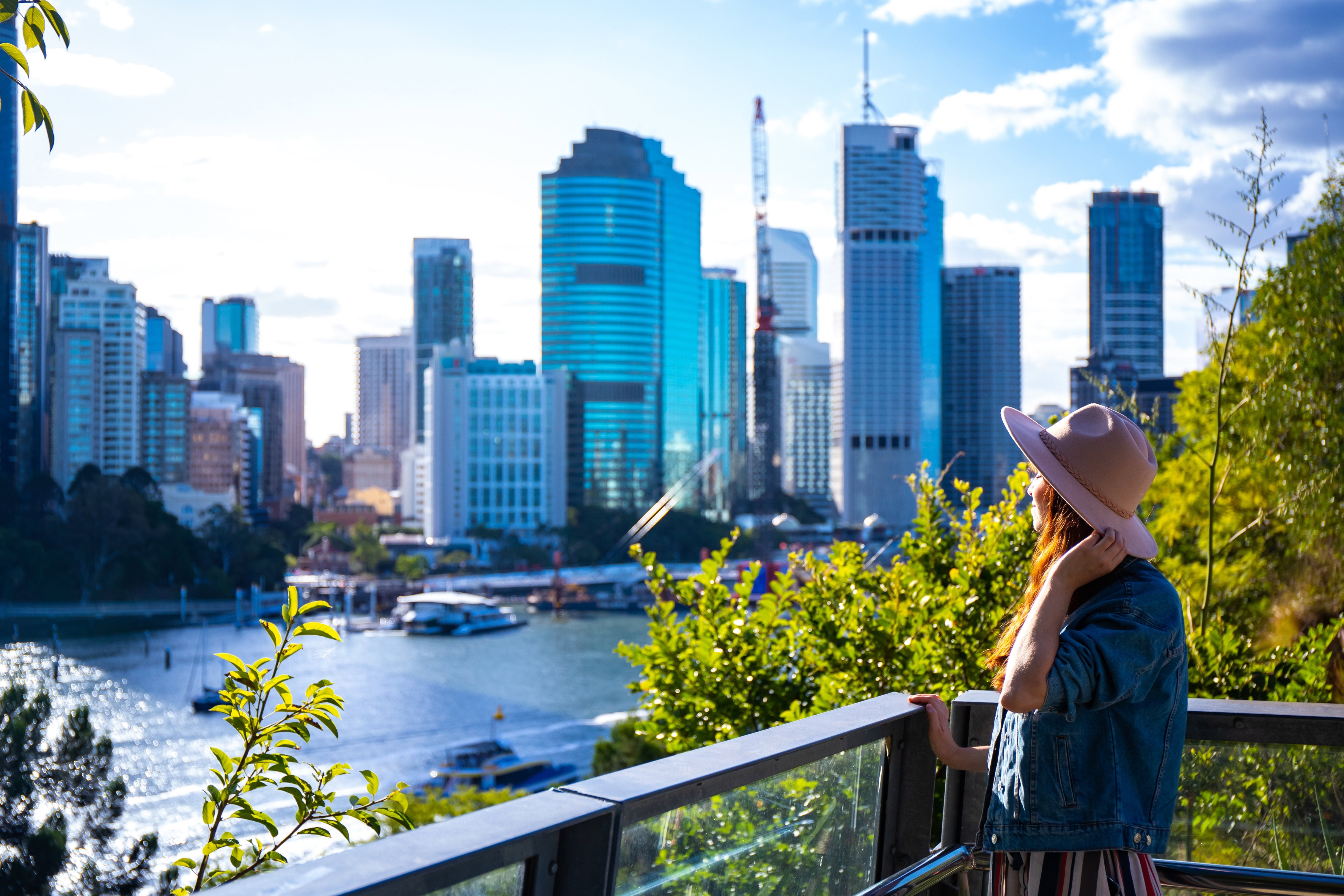 Young woman enjoying Brisbane CBD from Kangaroo Point, Australia