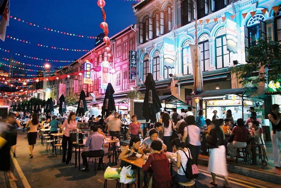 A busy street food market at night in Singapore