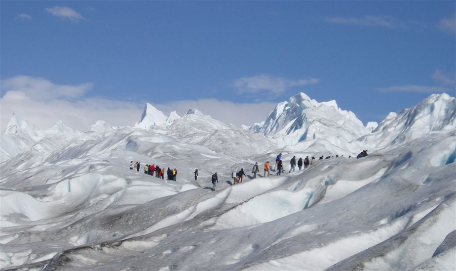 Hikers on an icy glacier in Argentina, South America