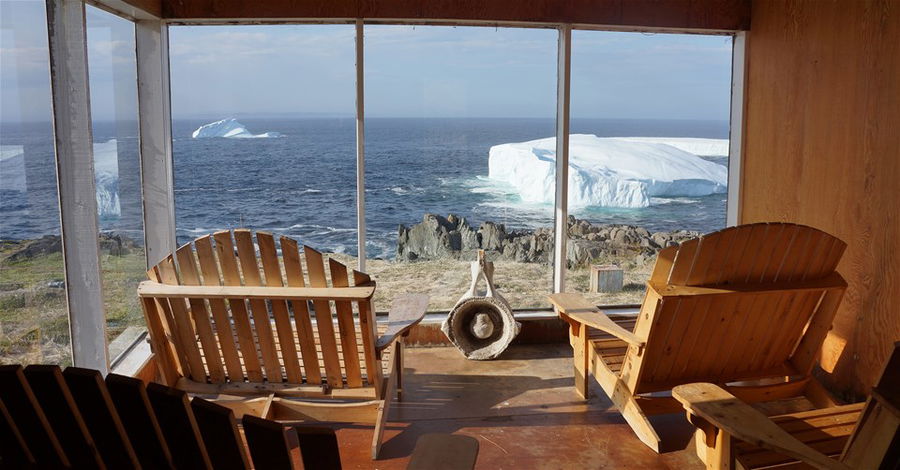 Two chairs look out on an icy landscape in Canada