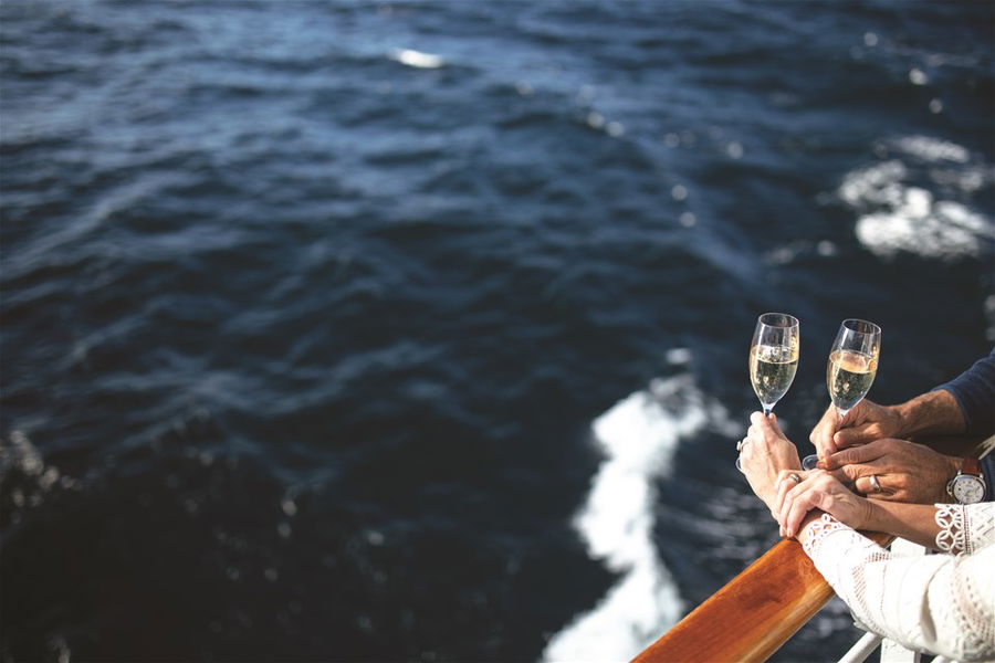 A couple drinking champagne on a cruise ship balcony