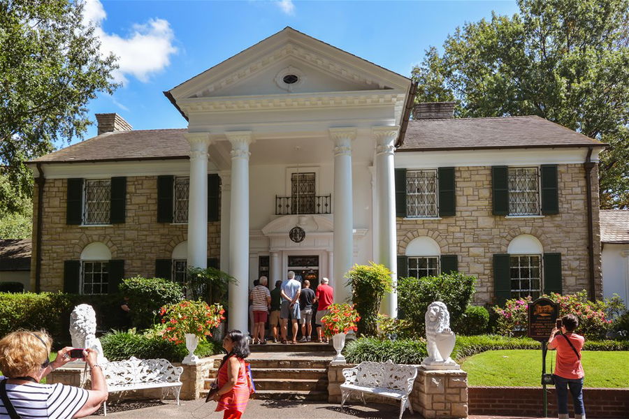 Tourists visit Graceland, the former home of Elvis Presley