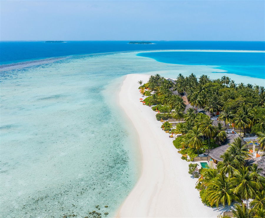 Aerial view of the overwater villas at the Angsana Velavaru resort in the Maldives