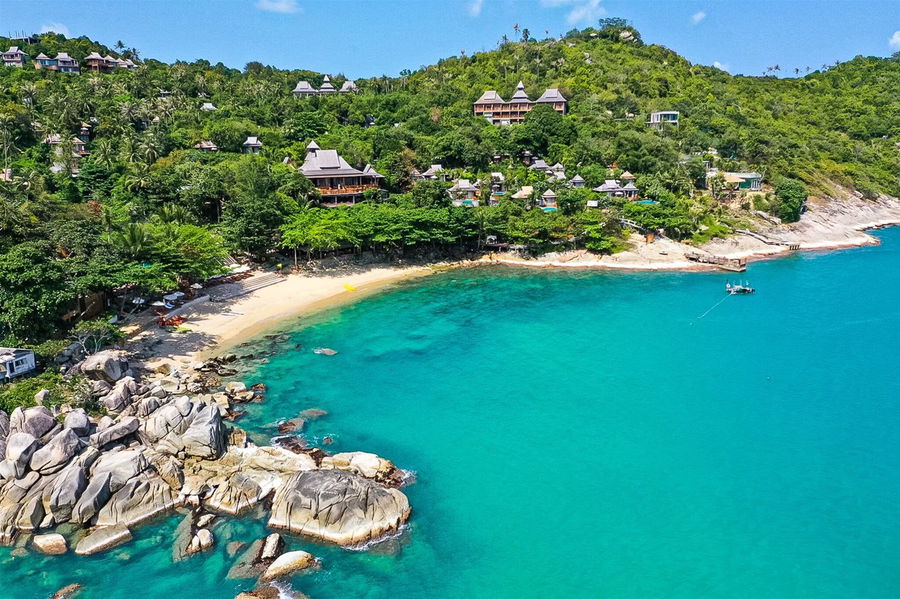 A beautiful empty cove in Thailand with a white sand beach