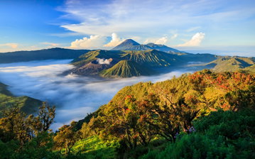 Stunning view of Mount Bromo at sunrise with smoke rising above from the volcano, in Indonesia