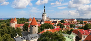 Castle turrets and church spires poke through the foliage surrounding Tallinn Old Town, Estonia