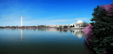 Panoramic shot on a bright summers’ day looking over the water at the Washington Memorial and the Thomas Jefferson Building in Washington DC, USA