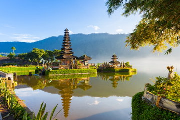 The spire of Ulun Danu temple with mountains in the background, Beratan Lake, Bali, Indonesia