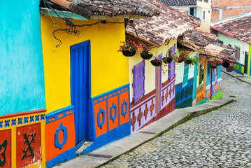 Colorful colonial houses on a cobblestone street in Guatape, Antioquia in Colombia
