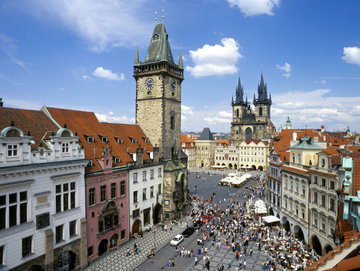 Crowds gather in the cobbled streets between the medieval buildings of Prague, Czech Republic
