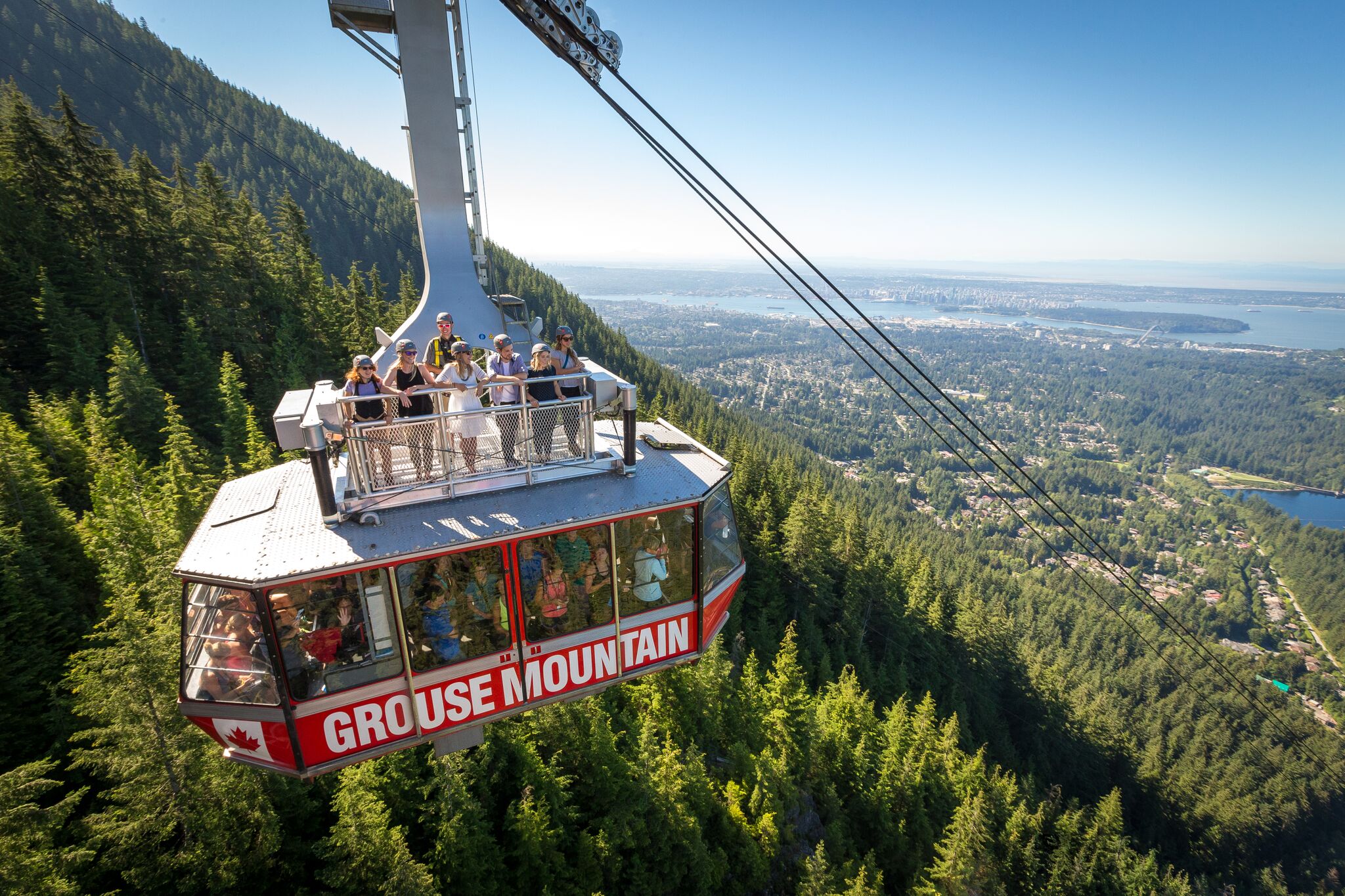 Visitors on a cable car high above the mountain and forest, Grouse Mountain Admission, Vancouver, British Columbia, Canada
