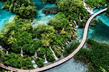 A wooden pathway weaves through Plitvice Lakes Croatia