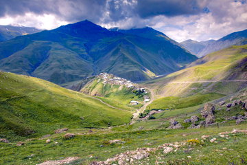 The small village of Xinaliq sits perched amongst the mountains on a dark cloudy day, Azerbaijan