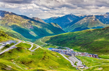 An aerial view of a lush, green mountain range in Andorra