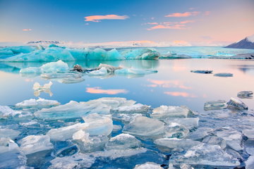 Icebergs floating in the still lagoon water at Jokulsarlon, Iceland.