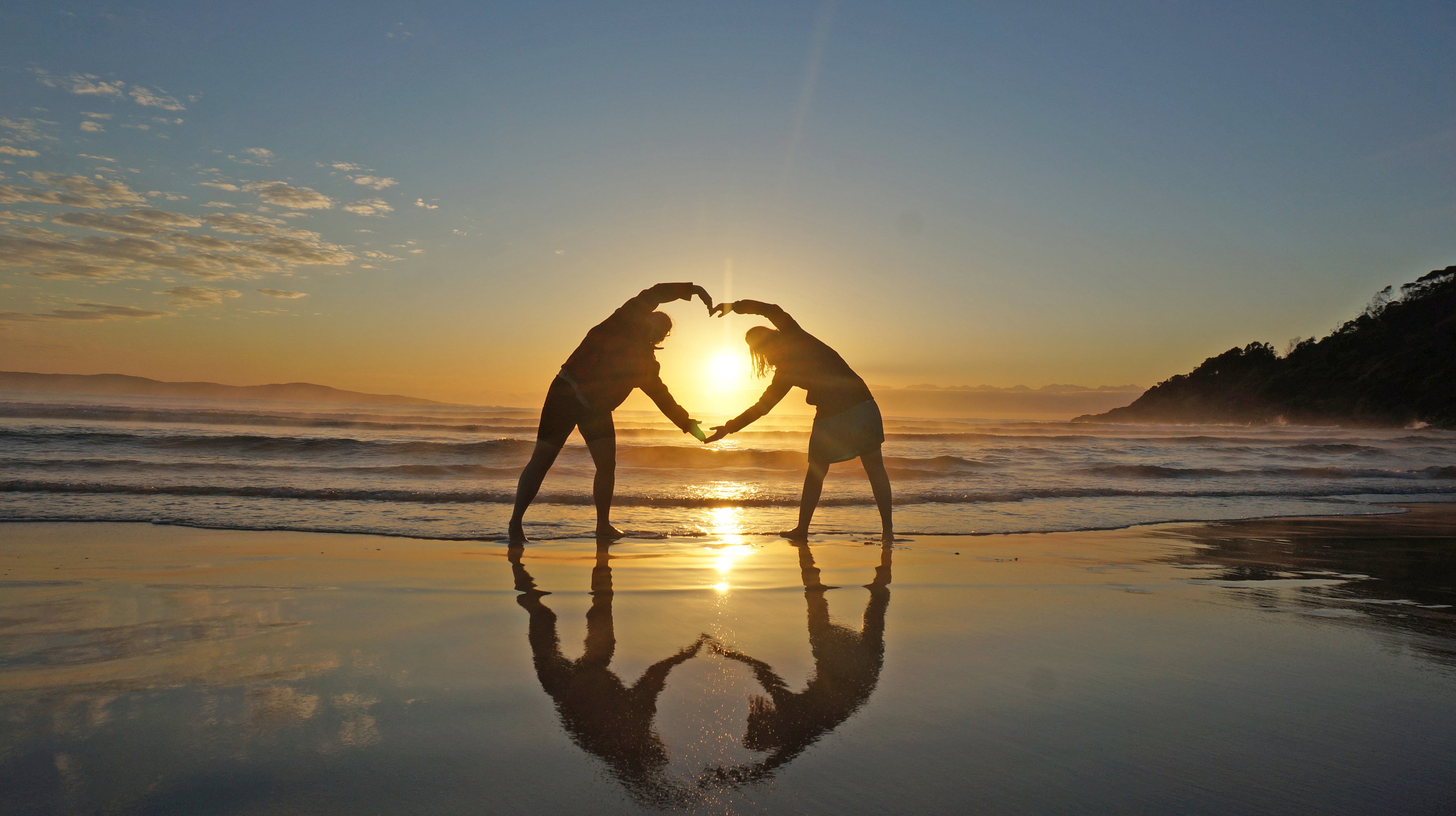 A couple on the beach at sunset
