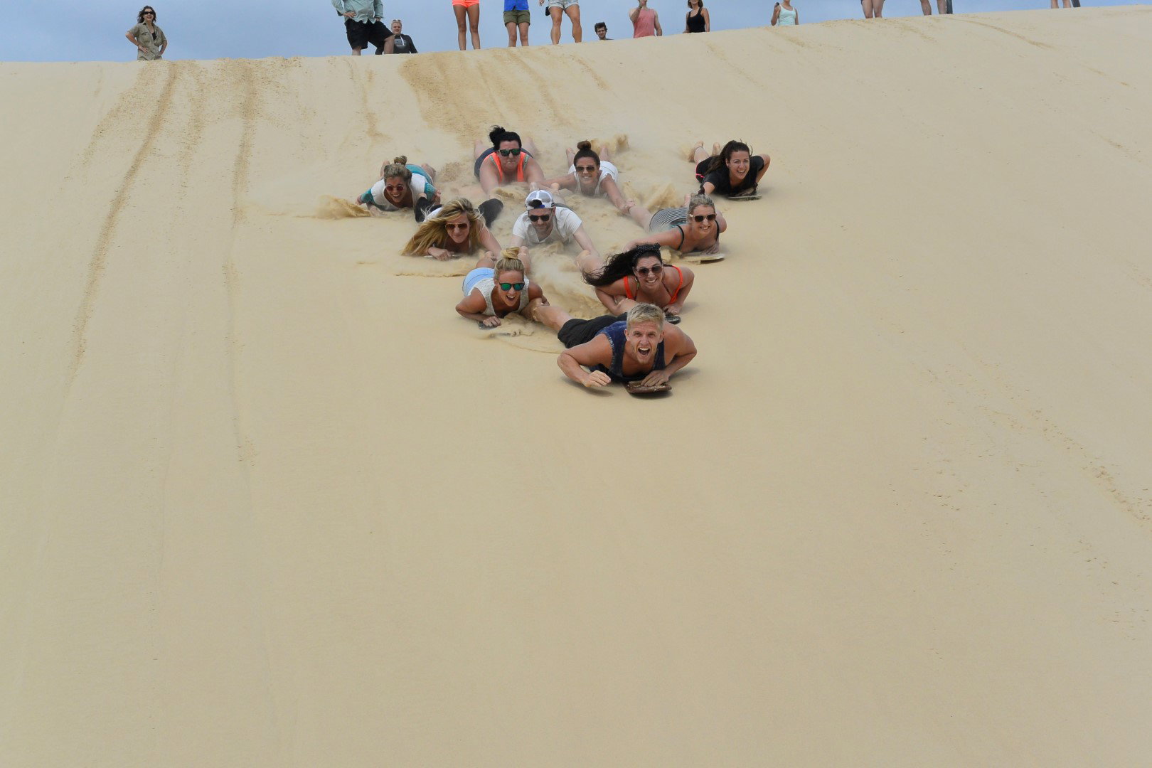 A group of young travellers sandboarding in Western Australia