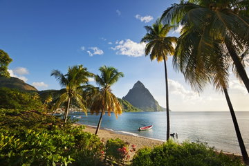 The twin volcanic peaks of the Pitons rise majestically from the sea, South West St Lucia.