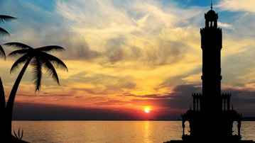 A beautiful red and orange sunset over the calm ocean in Izmir, Turkey
