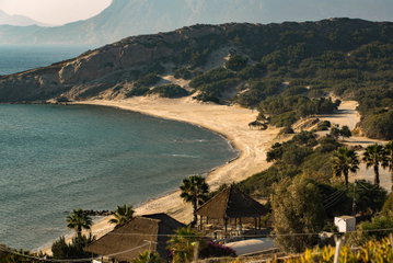 Sandy beach with and lush mountainous back drop in Kos, Greece. 