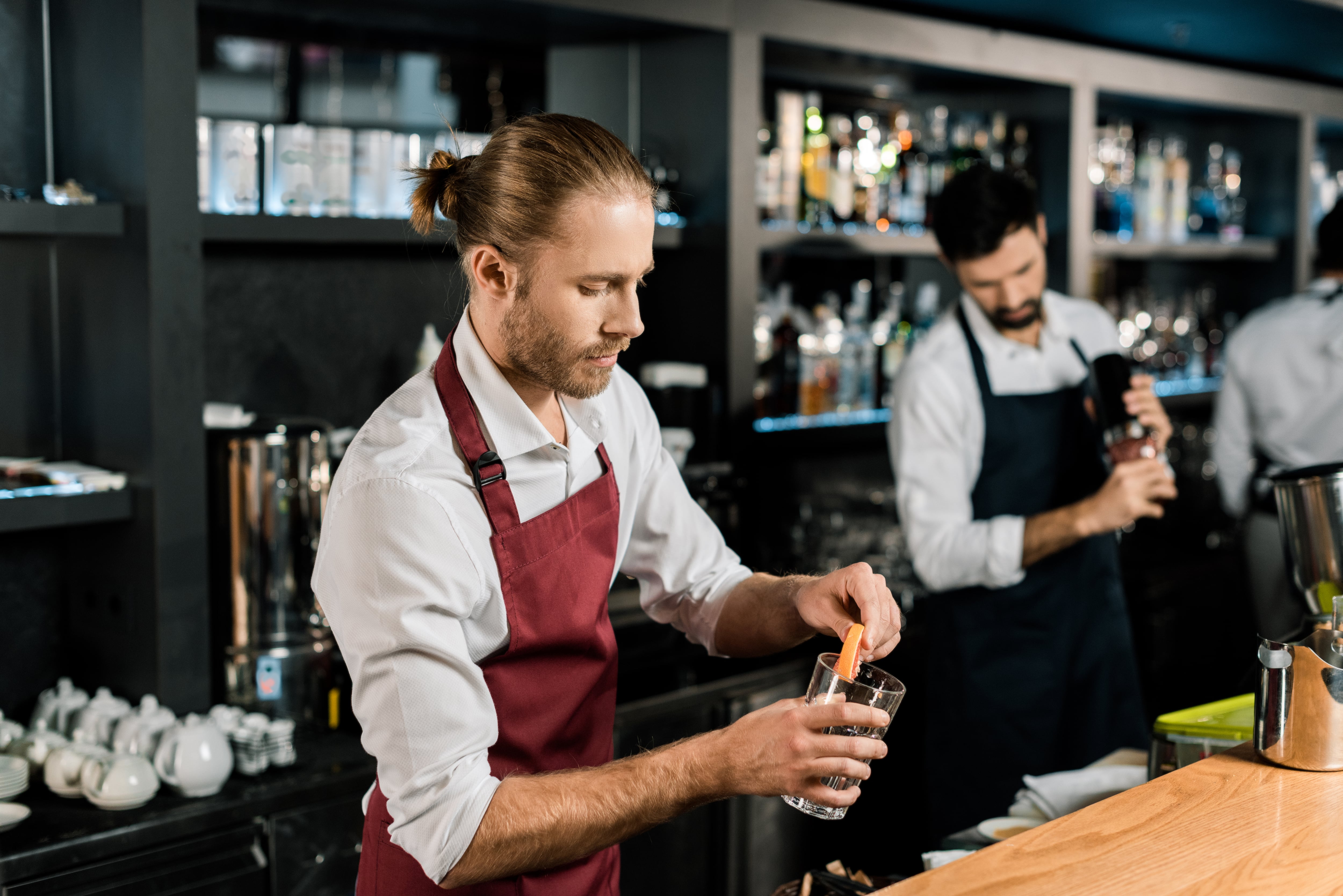barman decorating glass for cocktail in Australia