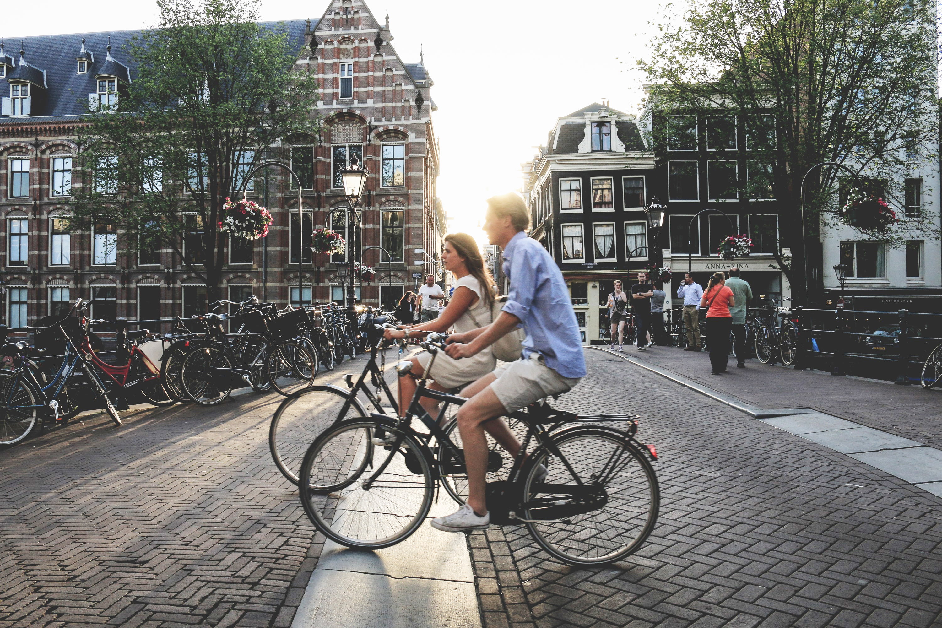 Young couple riding bikes in Amsterdam, Netherlands