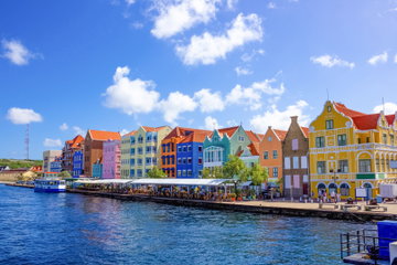 Coloured building and waterside cafés on a bright sunny day in Willemstad, Curacao