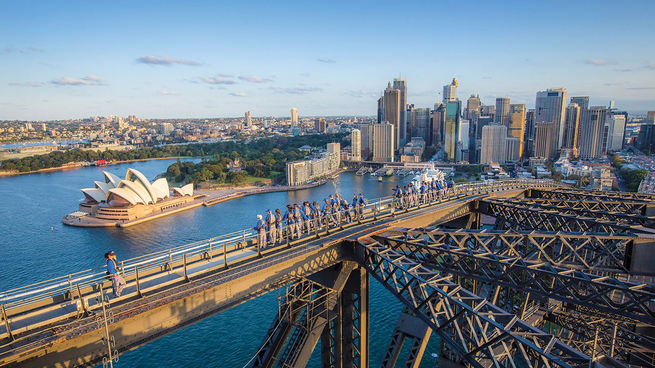 Visitors climbing the bridge with views of the Harbour, Opera House and city, on BridgeClimb Sydney - Day Climb, Australia.