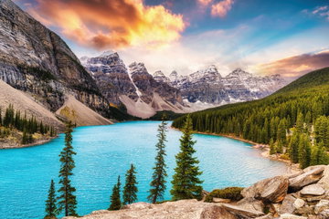 Turquoise waters of Moraine Lake, set against snow-capped peaks of the Canadian Rockies at sunrise in Banff National Park, Western Canada.
