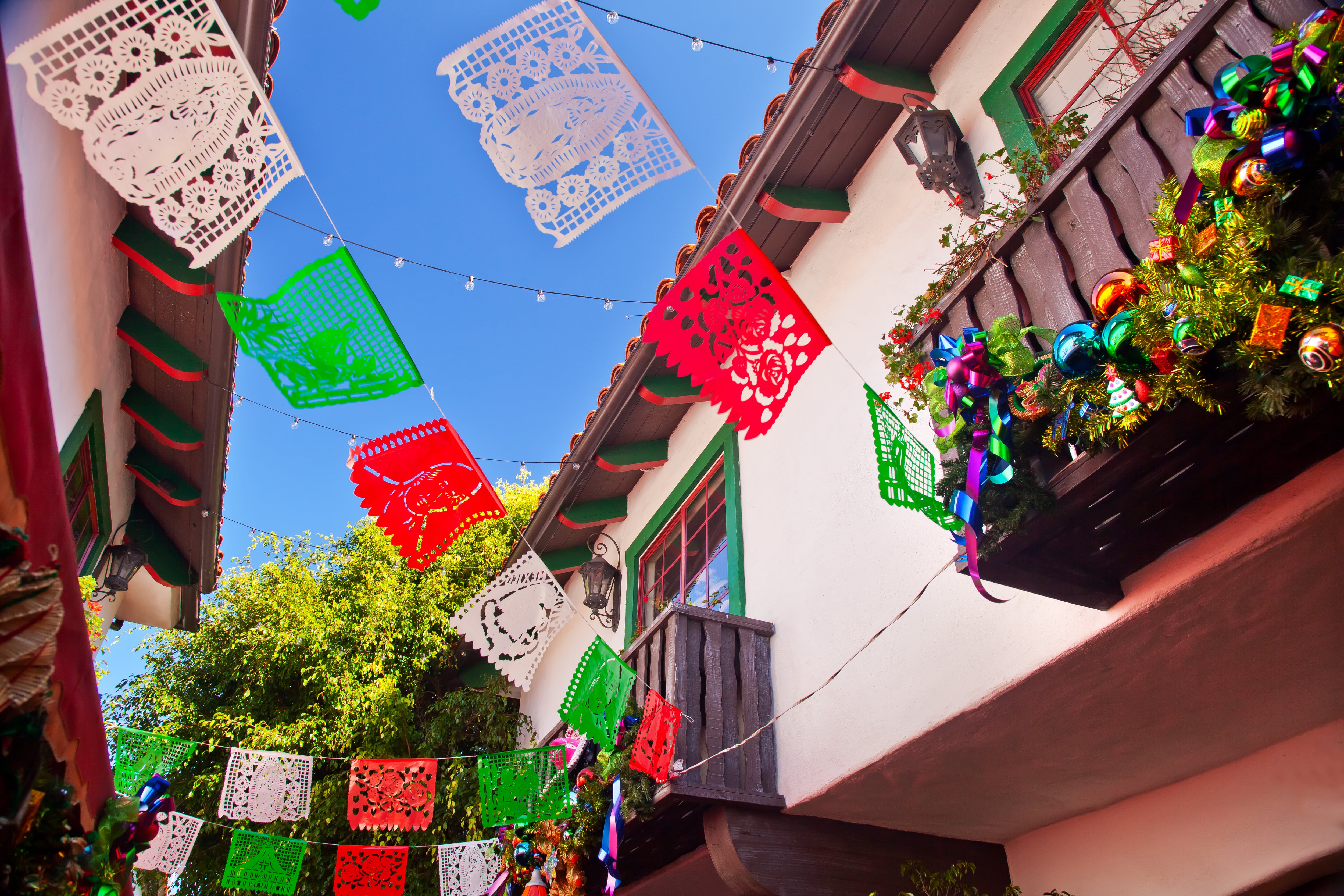 close up of the historic Mexican style buildings in San Diego’s Old Town, where colourful papel picado (Mexican bunting) is hung between buildings