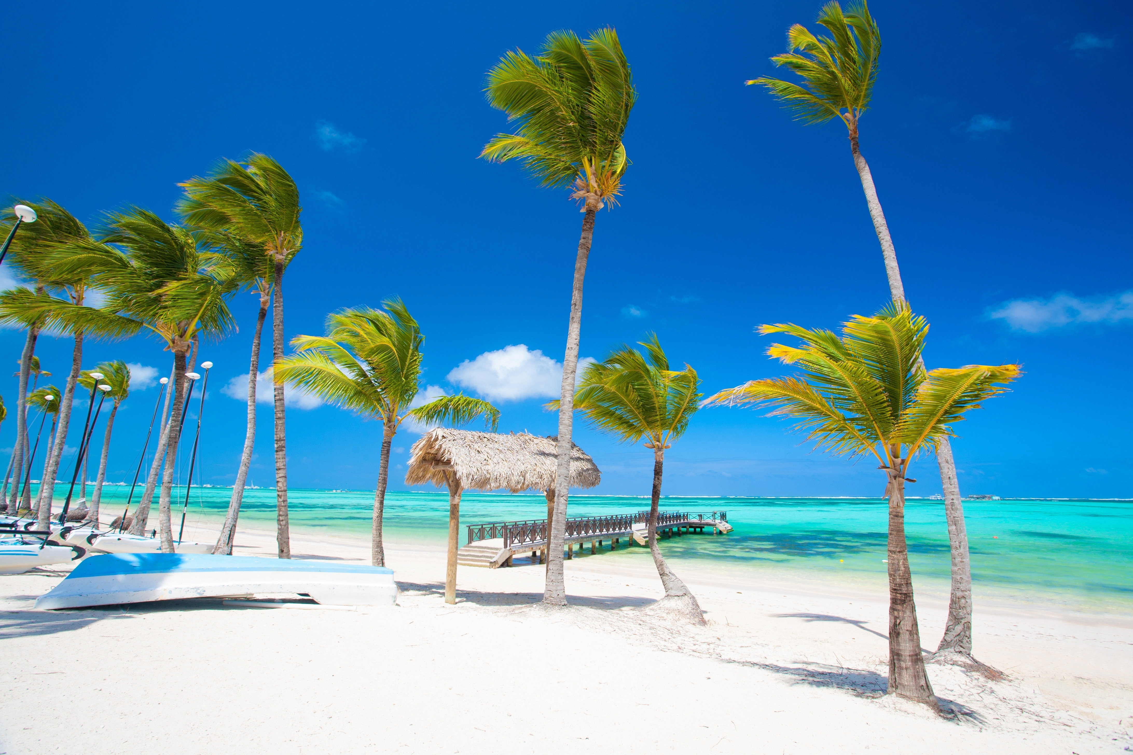 Two catamarans on a white sand beach beside the clear waters of the Indian Ocean at Breezes Beach Club & Spa, Zanzibar