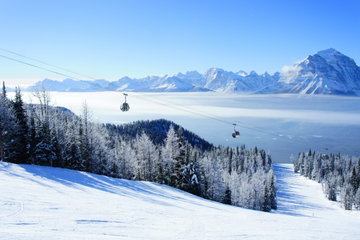 Picture of temperature inversion at Lake Louise, causing a cloud of sea with gondola visible.