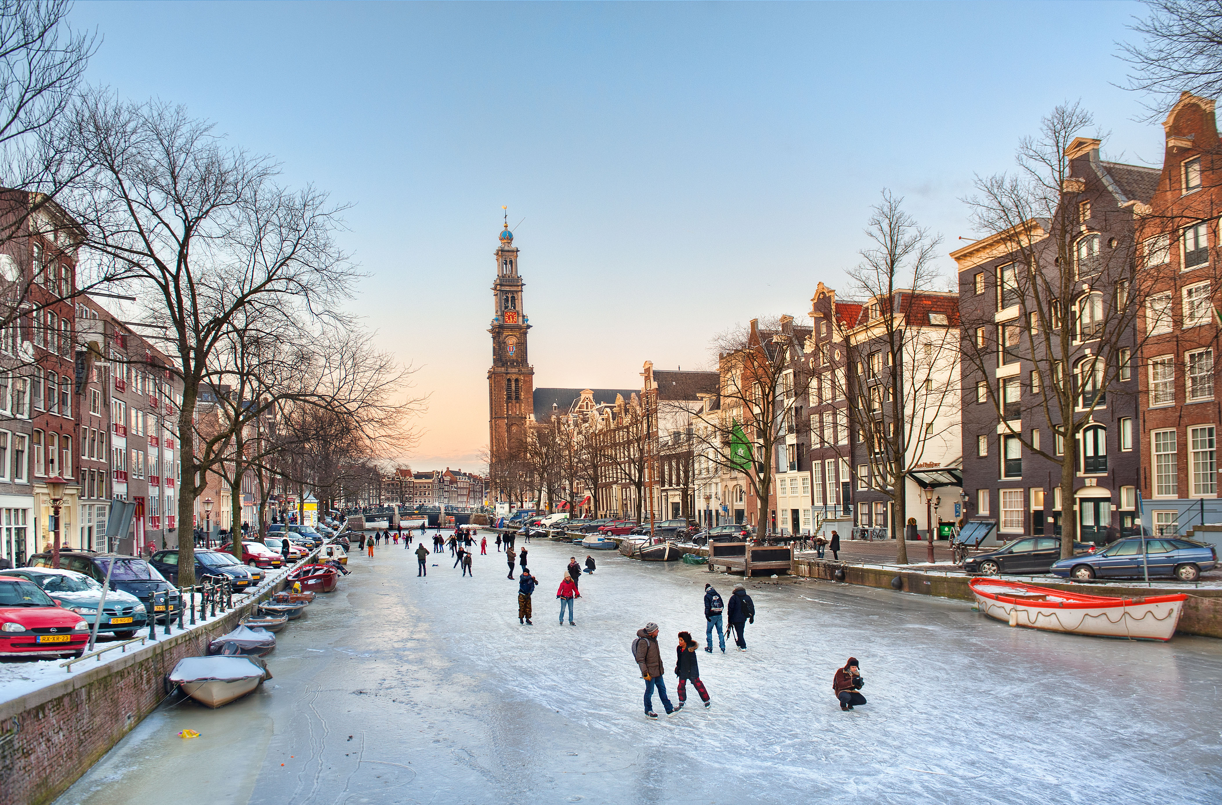Skaters enjoy the ice on a winter evening on the Prinsengracht in Amsterdam, the Netherlands