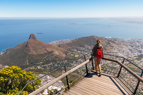 Young traveller woman enjoying view of Lions Head, South Africa from Table Mountain, Africa