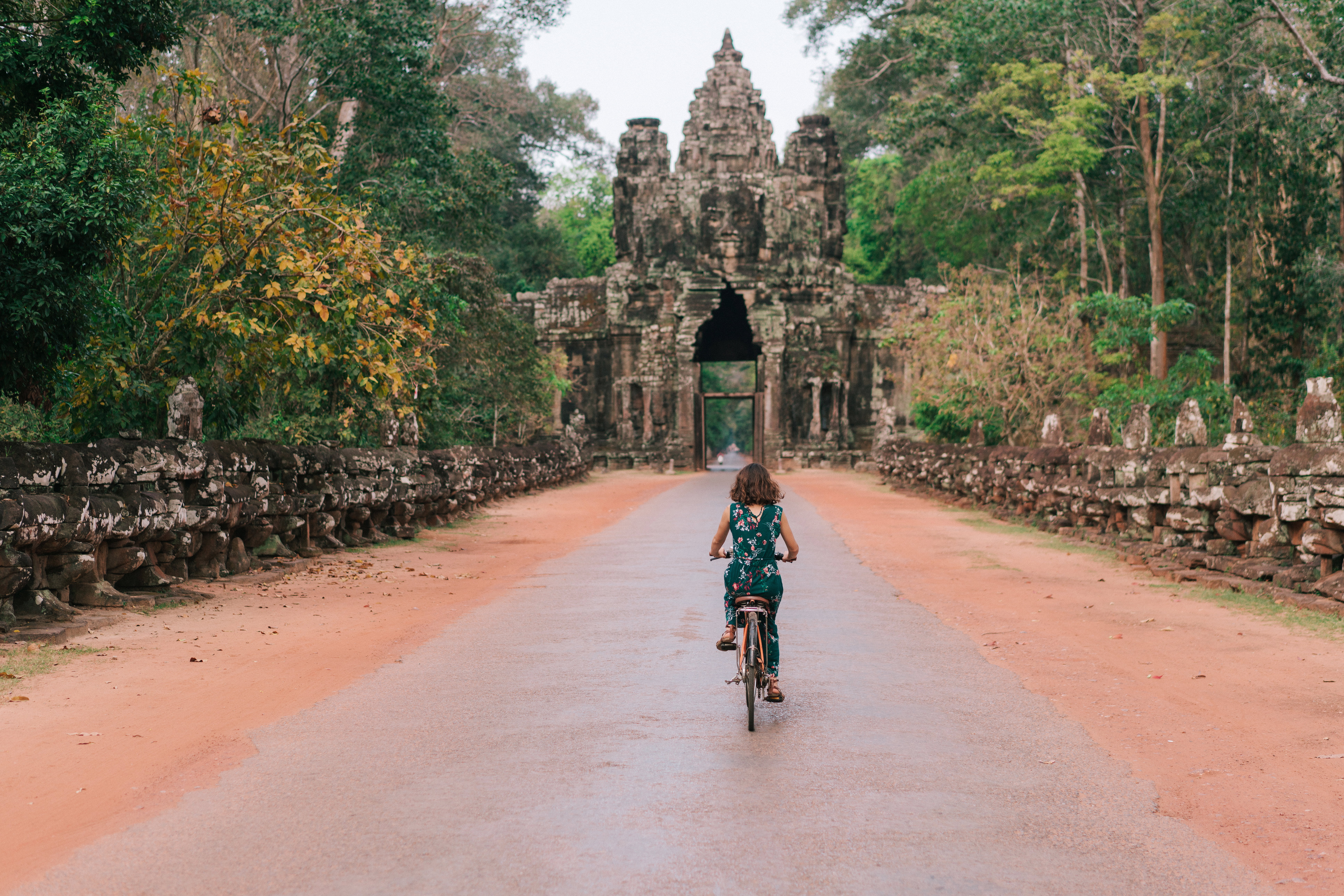 A young girl cycling through Angkor Wat in Cambodia