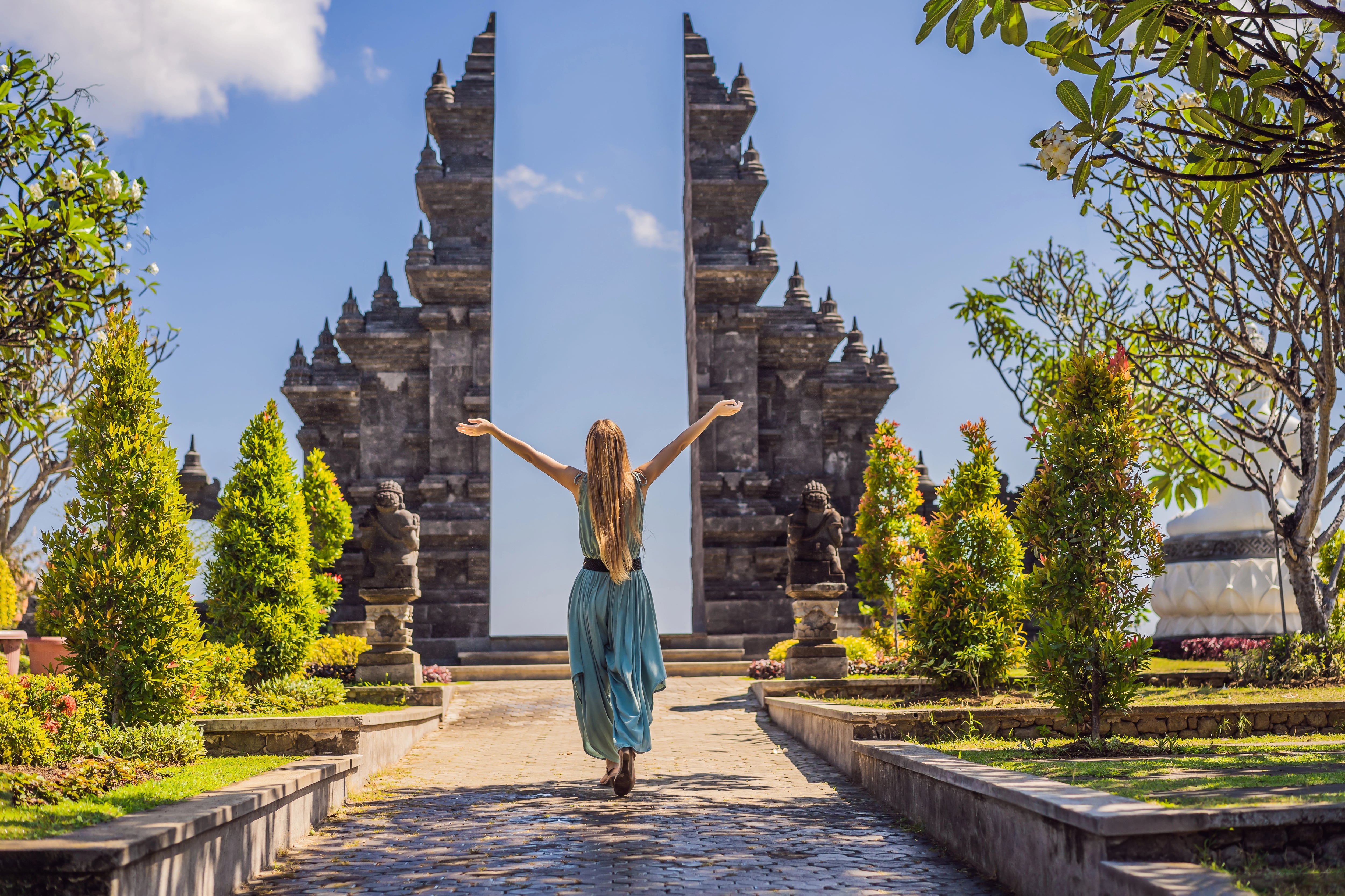 Young woman tourist in budhist temple Brahma Vihara Arama Banjar Bali, Indonesia