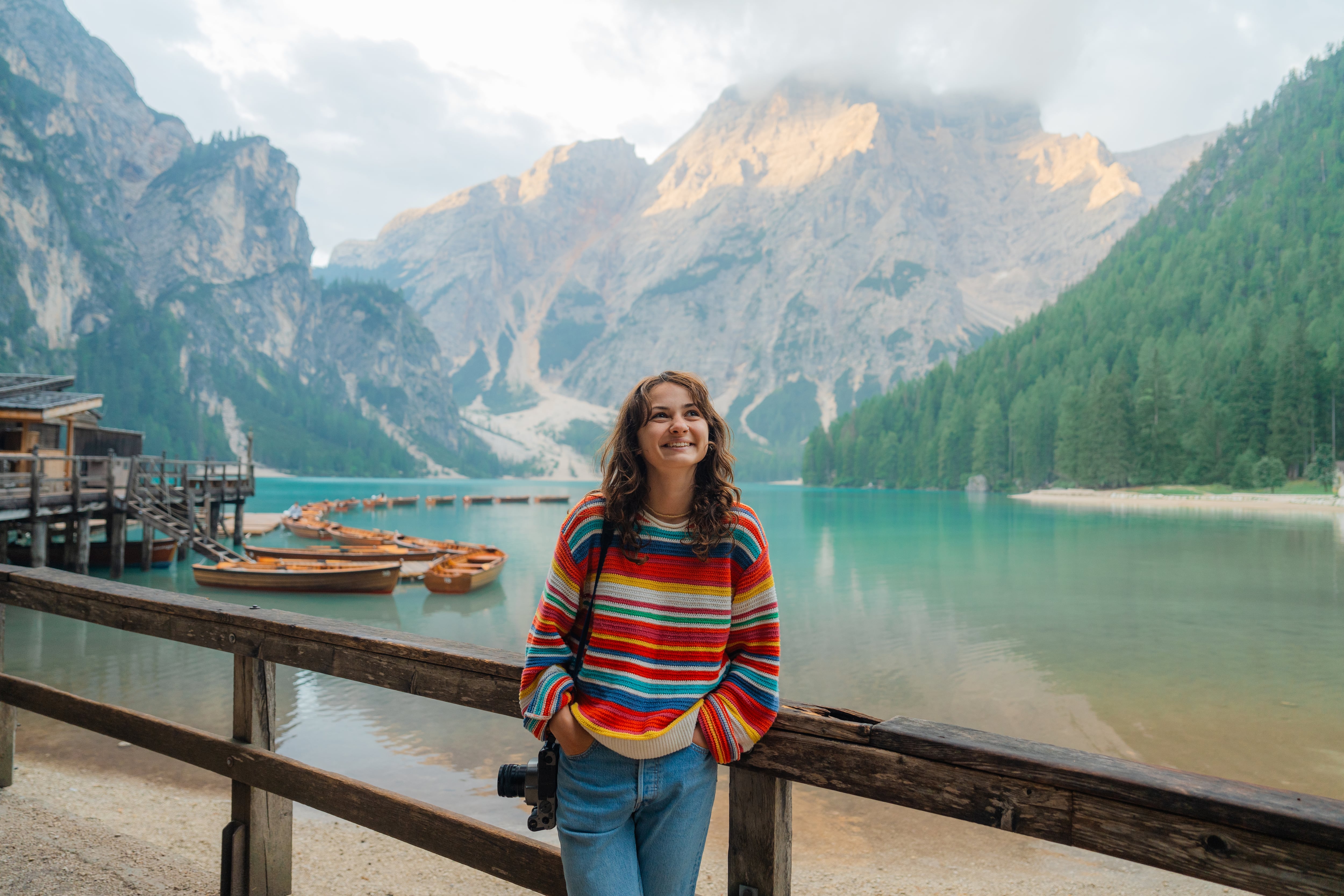 Woman with camera photographing at Lago di Braies, Italy