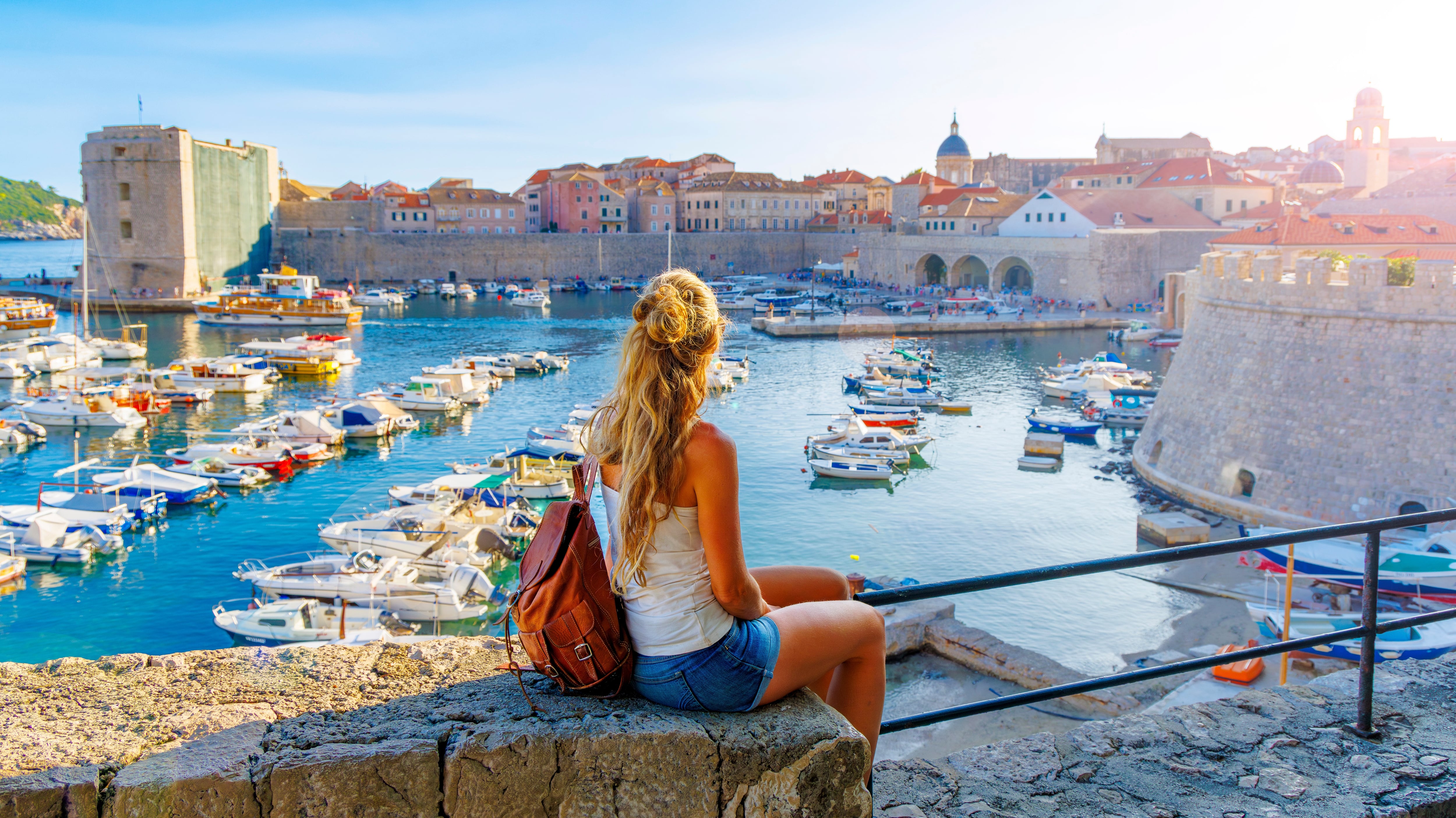 Woman in Dubrovnil old town and harbour, Dalmatia, Croatia