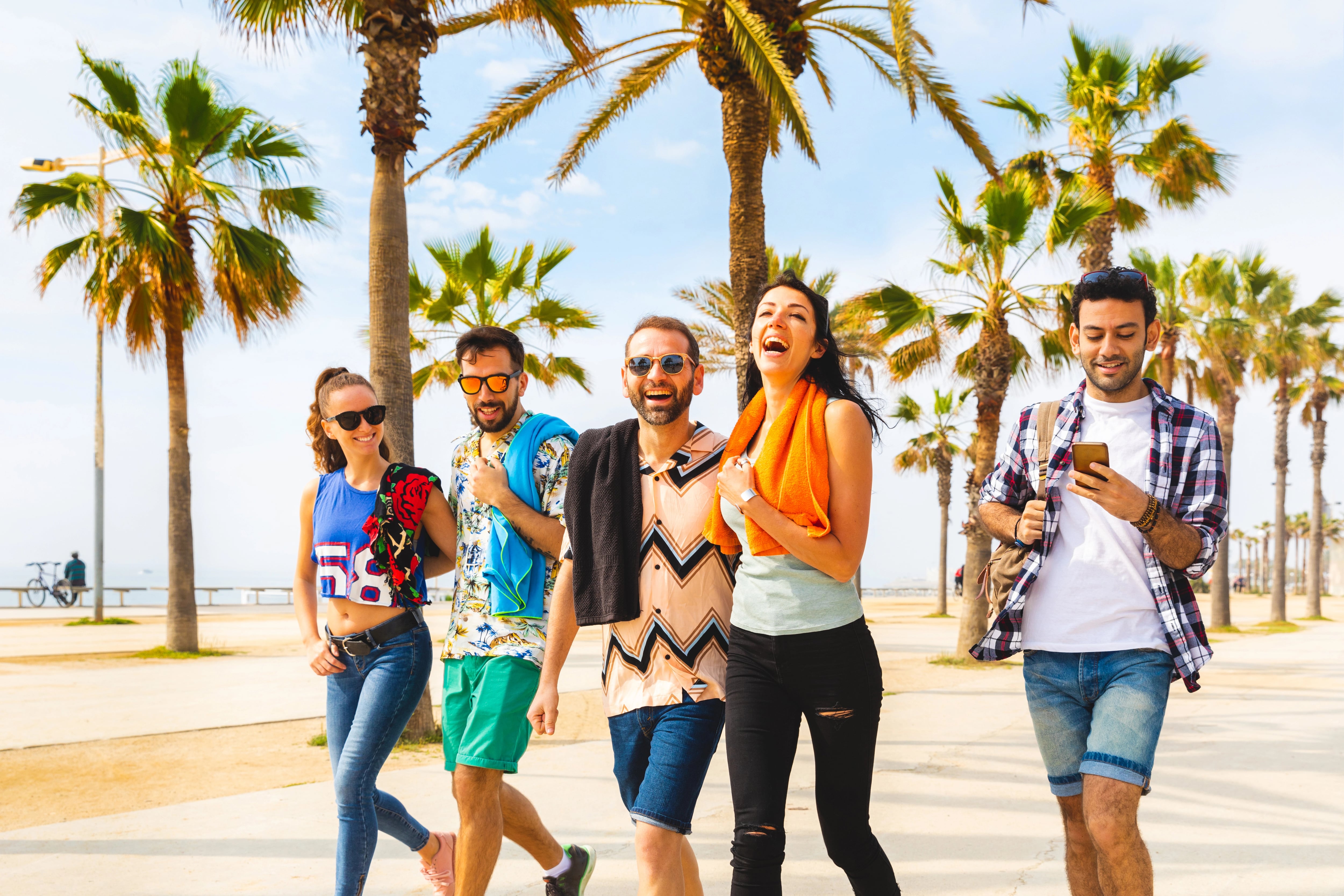Happy friends on seaside walk in Barcelona, Europe