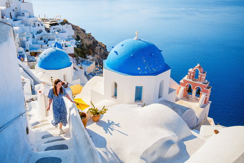 Young woman in Oia village on Santorini island, Greece